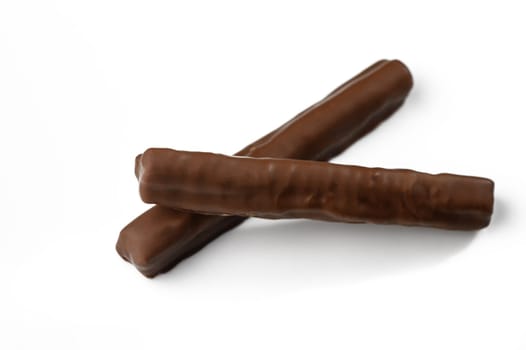 Two smooth chocolate bars rest against each other, inviting a delicious moment of sweet pleasure.