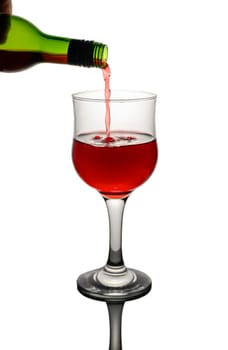 A rich, red beverage is poured elegantly into a stylish glass, exemplifying the joy of mixology at home.