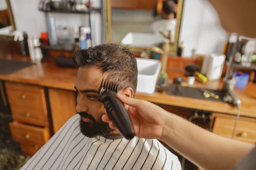 A highly skilled barber is expertly providing a stylish haircut in a modern and inviting barbershop environment