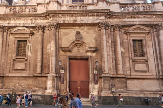 Catania. Italy - February 27, 2025: The striking San Michele Arcangelo ai Minoriti church anchors Catania streetscape. Great for heritage tours, urban lifestyle features, and photography projects.
