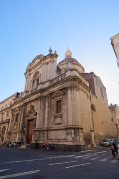 Catania. Italy - February 27, 2025: The elegant San Michele Arcangelo ai Minoriti church enhances Catania charm. Suited for lifestyle shoots, heritage explorations, and travel guides, it reflects Sicily architectural splendor under a radiant sun.