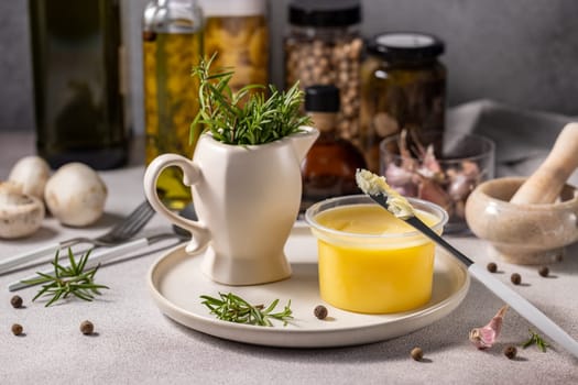 Ghee butter, infused with fresh rosemary and spices, sits ready for use, promising a flavorful culinary experience