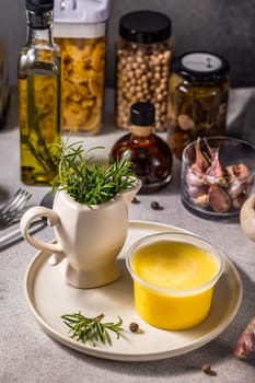 Aromatic rosemary sprigs, rich ghee butter, and various pantry staples crafting a warm culinary scene filled with flavor