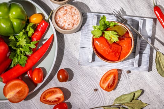 Delicious pickled red bell peppers served with fresh tomatoes, chili peppers, herbs, and spices, creating a vibrant and flavorful culinary scene