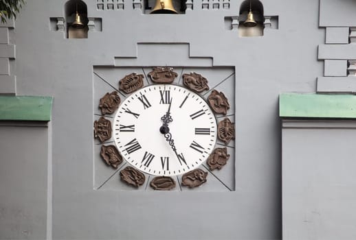 A large analog clock is prominently featured on a gray wall of a Clock Tower of a State bank in Nizhny Novgorod