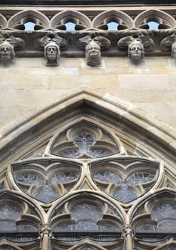 Intricate stonework adorns a historic facade in Carcassonne, France, showcasing artistry.