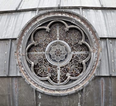 Intricate stained glass window design showcases artistry and craftsmanship in a historic structure located in Lourdes.