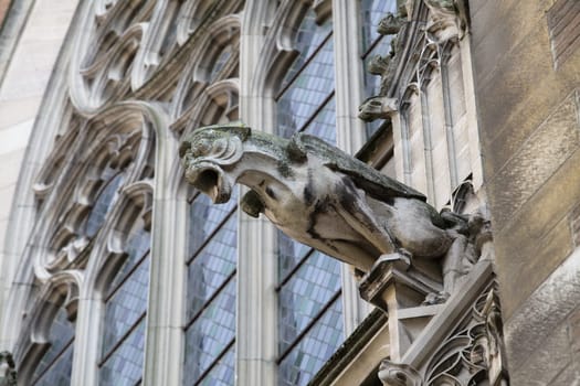 A dramatic stone gargoyle watches over Toulouse, reflecting the rich history of Cathedral Saint-Etienne.