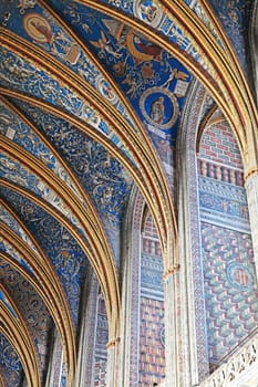 Explore the stunning arches and vibrant frescoes of Sainte-Secile cathedral on a sunny afternoon.