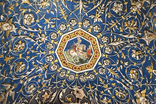 Colorful floral patterns surround a central depiction of a knight riding a horse, showcasing the cathedral's artistry.
