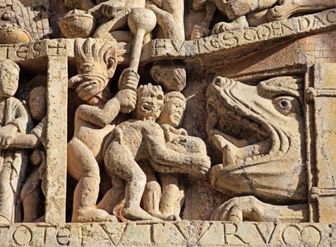 Stone reliefs showcase detailed figures and events from history, offering insight into the art of Conques, France.