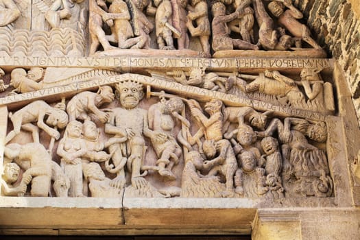 Stone reliefs showcase detailed figures and events from history, offering insight into the art of Conques, France.