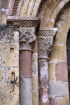 Elaborate stone columns with detailed carvings highlight the rich history and artistry found in Conques, France.