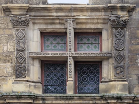 Intricate stone carvings on a historic window in Sarlat-la-Caneda showcase the area's rich architectural heritage.