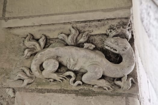 Intricate stone carving featuring a mythical creature found in Chamborg Castle, showcasing medieval artistry and design.