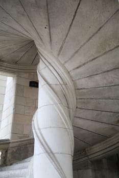 The spiral staircase at Chambord Castle boasts stunning details and elegant curves, inviting exploration.