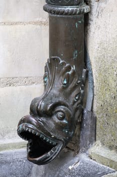Ornate downspout featuring a dragon design enhances the historical architecture of Chamborg castle in France.