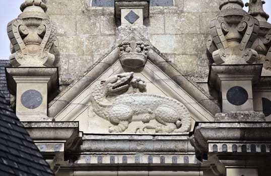 A detailed dragon carving crowns Chamborg castle in France, showcasing its rich historical architecture.