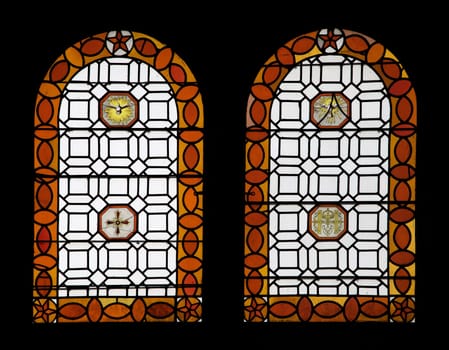 Stained glass windows at Chambord castle showcase colorful patterns and symbols, reflecting the historic architecture.