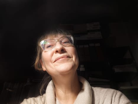 Blonde woman in her fifties smiles warmly, taking a lighthearted selfie as she shares her thoughts on lifestyle blogging.