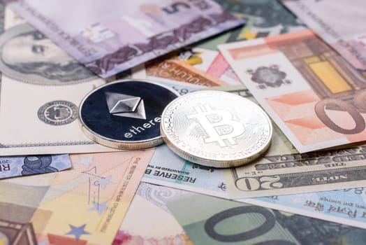 Round metal ethereum on a background of paper banknotes of different currencies. Background for your design