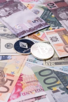 Round metal ethereum on a background of paper banknotes of different currencies. Background for your design