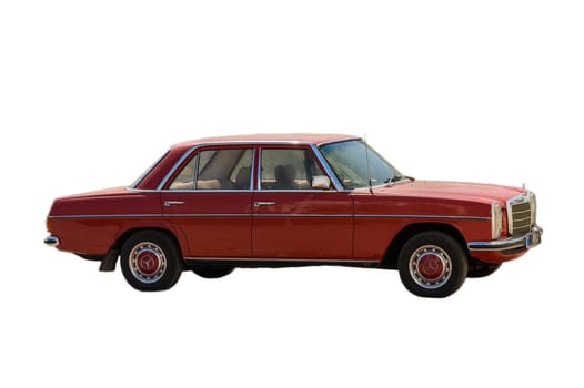 Gaziveren Cyprus -28.02.2025 A meticulously maintained red sedan stands out against a bright urban backdrop, showcasing its vintage charm.