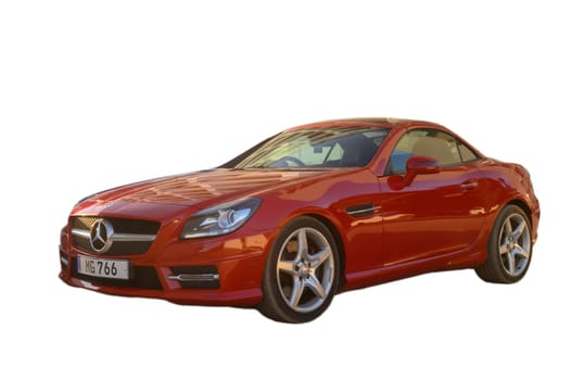 Gaziveren Cyprus -28.02.2025 A vibrant red sports car showcases its elegant design under bright sunlight in an outdoor setting.
