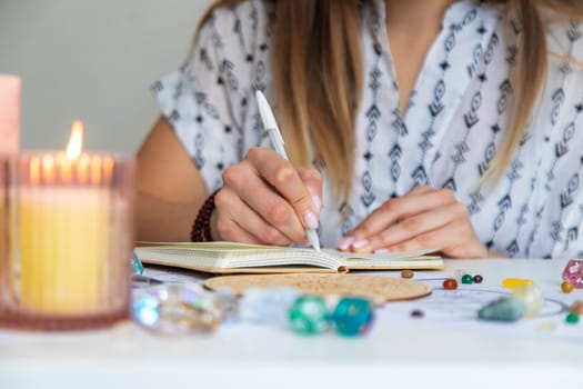 Woman astrologer draws a natal chart. Selective focus.