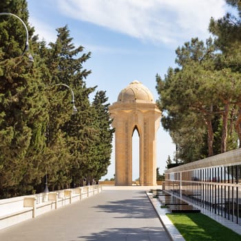 Baku, Azerbaijan - May 6 2024: Martyrs Lane honors fallen soldiers in the Nagorno-Karabakh Conflict. It features soldiers' graves and a central monument, an imposing stone tower with an eternal flame