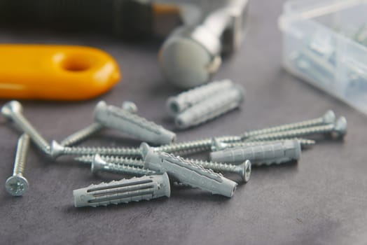 Tools and hardware are spread out on a surface ready for a project.