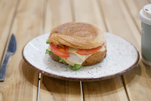 Delicious sandwich made with a flaky croissant and fresh ingredients.