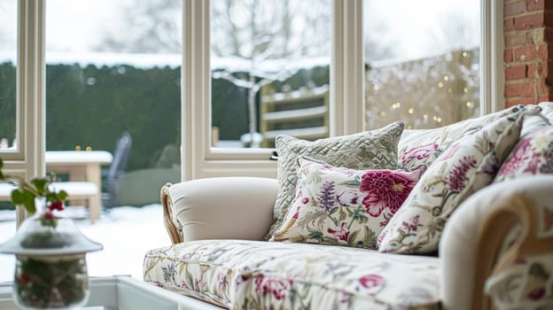 Colorful pillows on sofa against glass wall of window in a winter garden or conservatory. Interior textile concept. High quality photo