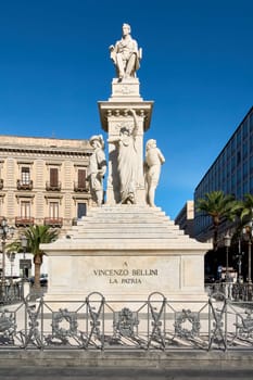 Catania. Italy - March 3, 2025: Stunning marble monument dedicated to composer Vincenzo Bellini, featuring intricate statues and a grand pedestal in Catania's vibrant square. Perfect for cultural.