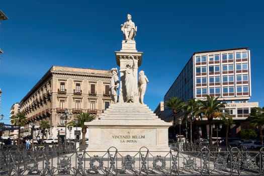 Catania. Italy - March 3, 2025: Impressive Vincenzo Bellini monument with elegant marble statues, set in a lively Catania square. Ideal for travel, culture, and history lovers.