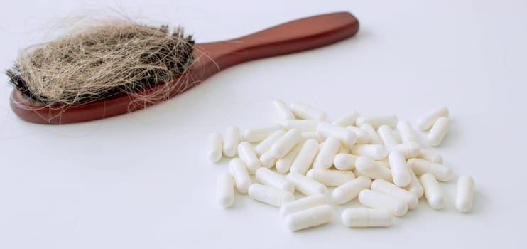 hair brush with hair and vitamins. hair loss.