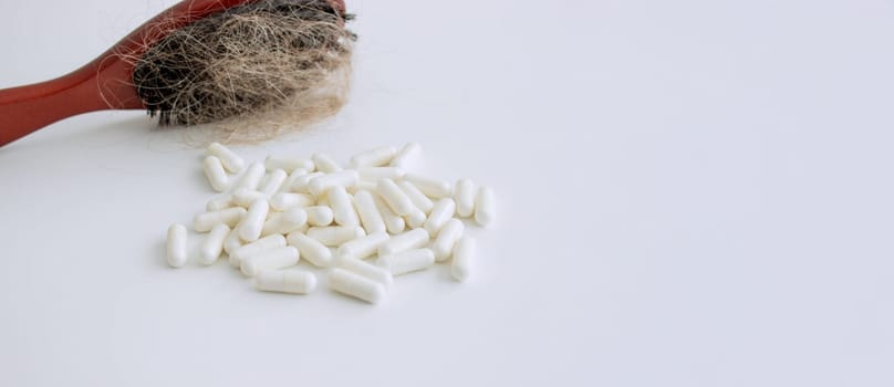 hair brush with hair and vitamins. hair loss.