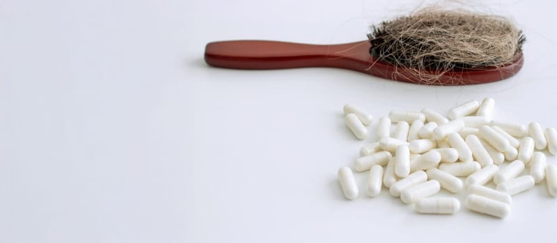 hair brush with hair and vitamins. hair loss.