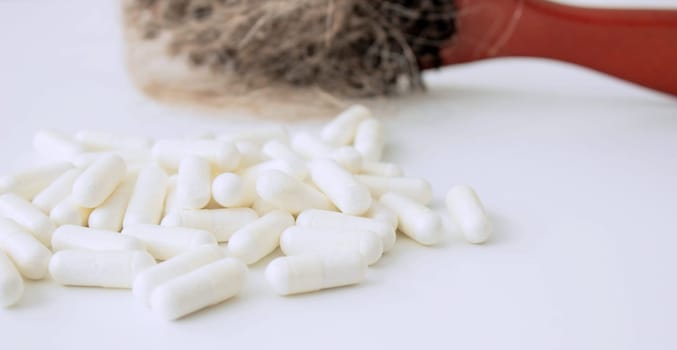 hair brush with hair and vitamins. hair loss.