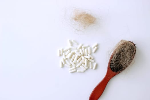 hair brush with hair and vitamins. hair loss.