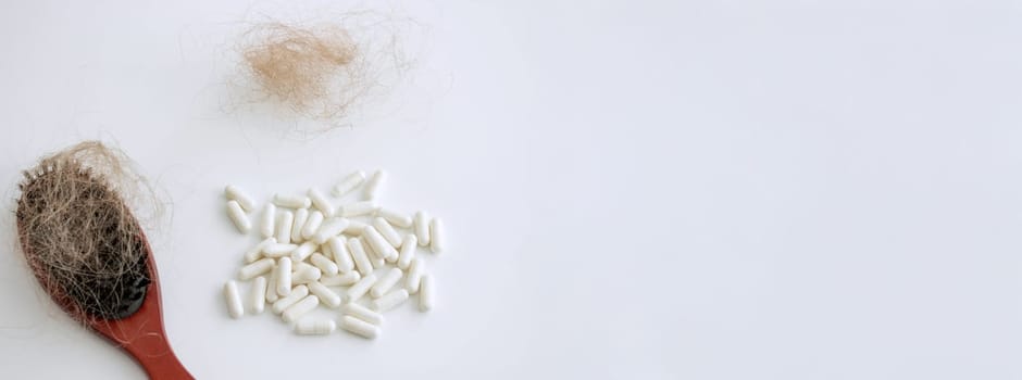 hair brush with hair and vitamins. hair loss.
