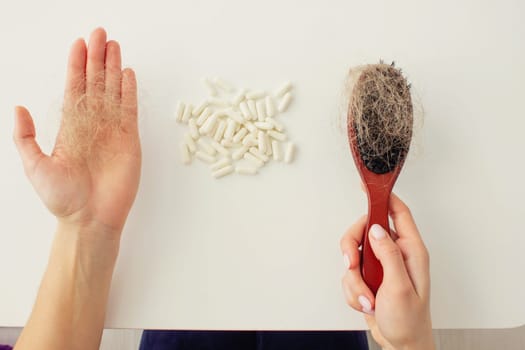 hair brush with hair and vitamins. hair loss.
