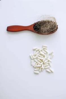 hair brush with hair and vitamins. hair loss.