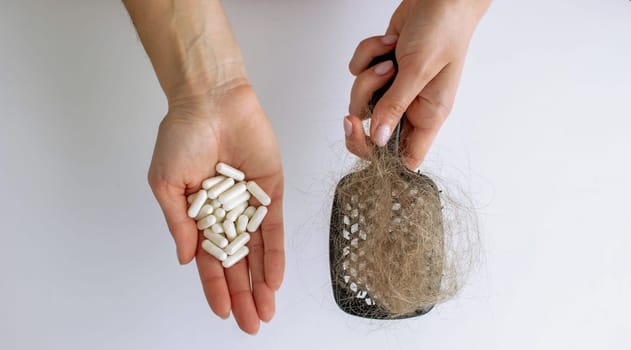 hair brush with hair and vitamins. hair loss.
