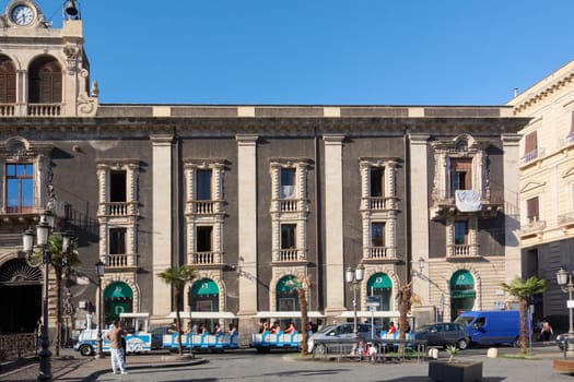 Catania. Italy - March 3, 2025: Majestic Palazzo Asmundo Di Gisira with ornate balconies and a tourist train in front. Perfect for travel, architecture, and urban tourism photography under.