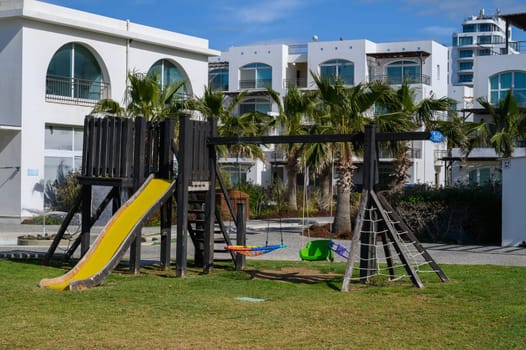 Children can enjoy a vibrant playground with slides and swings surrounded by serene coastal homes.