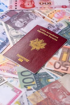 International passport of a citizen of France on background of paper banknotes of different countries