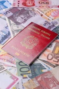 International passport of a citizen of Italy on background of paper banknotes of different countries
