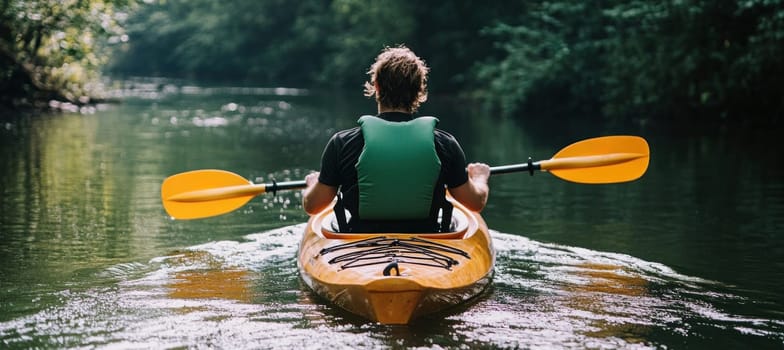Man paddling kayak on river in beautiful nature, enjoying summer vacation