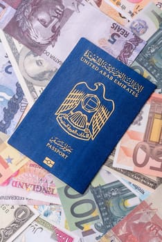 International passport of a citizen of United Arab Emirates against the paper banknotes